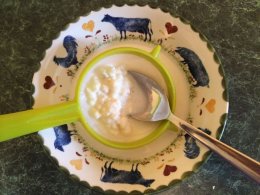 Kefir yoghurt strained through a plastic sieve
